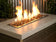 Load image into Gallery viewer, American Fire Products 1/2 inch Copper reflective fire glass installed in outdoor fire pit creating warm flame reflections