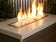 Load image into Gallery viewer, merican Fire Products 1/2 inch Gold reflective fire glass installed in outdoor fire pit creating golden flame reflections