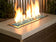 Load image into Gallery viewer, American Fire Products 1/4 inch Azuria reflective fire glass used in an outdoor fire pit creating a vibrant blue flame reflection