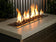 Load image into Gallery viewer, American Fire Products Auburn Recycled Medium Fire Glass displayed in an outdoor fire pit with flames reflecting through the auburn glass