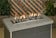 Load image into Gallery viewer, American Fire Products large gray lava stone 2 to 4 inch fire pit media use case in gas fire pit with flames and decorative lava rock