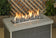 Load image into Gallery viewer, American Fire Products medium gray lava stone 1–2 inch fire pit media use case showing decorative volcanic rock in gas fire pit with flames and enhanced flame performance