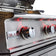 Load image into Gallery viewer, Stainless steel grill with Blaze Professional branding and red interior lights.