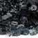 Load image into Gallery viewer, Close up of 1/2 inch Black Fire Glass showing black tempered glass pieces with a smooth glossy finish