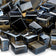Load image into Gallery viewer, Close up of American Fire Products Bronze Luster 2.0 Fire Glass Cubes showing bronze tempered glass with a reflective luster finish