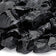 Load image into Gallery viewer, Close up of Onyx Medium tempered fire pit glass showing glossy black decorative glass pieces with reflective shine