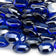Load image into Gallery viewer, Close up of Royal Blue Luster fire beads showing rich blue tempered glass with reflective gemstone-like shine