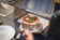 Load image into Gallery viewer, Festavolo Pizza Oven cooking pizza on a Festavolo grill table