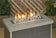 Load image into Gallery viewer, Fireplace linear lite stones in cape grey finish with visible flame, modern ceramic fire media arranged in a linear gas fireplace for indoor and outdoor fire features.