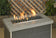 Load image into Gallery viewer, Matte black linear lite stones in a fireplace with visible flames creating a modern and elegant fire feature display