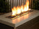 Load image into Gallery viewer, Indoor fireplace featuring Twilight Luster fire beads with dark glass reflecting bright yellow flames