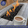 Load image into Gallery viewer, Natural volcanic lava rocks used as a base and decorative layer in an outdoor fire pit, enhancing heat distribution and aesthetics