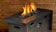 Load image into Gallery viewer, Modern outdoor fire pit featuring Black Luster 2.0 Fire Glass Cubes reflecting flames with a sleek luxury appearance