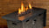 Load image into Gallery viewer, Luxury outdoor fire pit featuring Copper Luster 2.0 Fire Glass Cubes with warm flame reflections across copper glass cubes