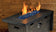 Load image into Gallery viewer, Luxury outdoor fire pit featuring Pacific Blue Luster 2.0 Fire Glass Cubes with blue glass reflecting warm flames