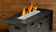 Load image into Gallery viewer, Luxury outdoor fire pit featuring Starfire Luster 2.0 Fire Glass Cubes with bright flames reflecting through clear glass cubes