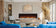 Load image into Gallery viewer, Napoleon Astound FlexMount 74-inch linear electric fireplace NEFL74AB recessed into a contemporary living room wall above built-in cabinetry, with blue sofas.