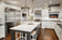 Load image into Gallery viewer, Napoleon Entice 36-inch electric fireplace installed on the wall of a modern white kitchen