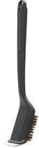 Load image into Gallery viewer, Angled view of Napoleon GABR001 Essential Series grill brush showing natural Palmyra bristles, black handle and stainless steel scraper