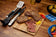 Load image into Gallery viewer, Napoleon GATL002 grilling tools displayed beside grilled steaks and vegetables on an outdoor dining table