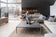 Load image into Gallery viewer, Napoleon Luminex 65 two-sided electric fireplace installed in a modern living room with a woman and dog