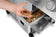 Load image into Gallery viewer, Hand adding wood chips to the optional smoker box drawer on a Napoleon Prestige PRO 500