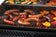 Load image into Gallery viewer, Grilled sausages and vegetables on a barbecue grill