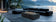 Load image into Gallery viewer, Planika Cabo Fire Table Laurent installed on a luxury outdoor patio with elegant flames