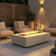Load image into Gallery viewer, Planika Cabo Fire Table Nacre installed on a modern outdoor patio with decorative flames