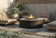 Load image into Gallery viewer, Planika Comet Fire Table Daze installed on a modern outdoor terrace with decorative flames