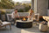 Load image into Gallery viewer, Planika Comet Fire Table Kreta installed on a modern outdoor patio with decorative flames