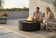 Load image into Gallery viewer, Planika Comet Fire Table Laurent installed on a luxury outdoor terrace with decorative flames