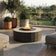 Load image into Gallery viewer, Planika Comet Fire Table Nacre installed on a modern outdoor terrace with decorative flames