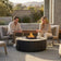 Load image into Gallery viewer, Planika Comet Fire Table Nacre installed on a modern outdoor terrace with decorative flames