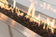 Load image into Gallery viewer, Close-up of Planika Galaxy 1150 stainless steel outdoor gas burner with black glass gravel