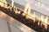Load image into Gallery viewer, Close-up of Planika Galaxy Table burner with black glass gravel and decorative flames