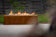 Load image into Gallery viewer, Planika Galio Corten Manual freestanding outdoor gas fireplace installed on modern patio