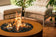 Load image into Gallery viewer, Planika Galio Star Corten outdoor gas fireplace installed on luxury patio with multidimensional flames