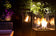 Load image into Gallery viewer, Planika Lighthouse gas patio heater in modern outdoor patio setting with warm flame ambiance