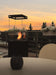 Load image into Gallery viewer, Planika Lighthouse gas patio heater in modern outdoor patio setting with warm flame ambiance