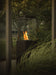 Load image into Gallery viewer, Planika Lighthouse gas patio heater in modern outdoor patio setting with warm flame ambiance