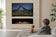 Load image into Gallery viewer, Modern living room with Planika NEX Media Wall sliding TV mechanism and integrated fireplace system