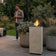 Load image into Gallery viewer, Planika Porto Nacre freestanding fireplace used in a modern outdoor lounge area