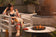 Load image into Gallery viewer, Planika Stella Daze outdoor gas fire table installed on modern luxury patio with decorative flames