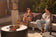 Load image into Gallery viewer, Planika Stella Daze outdoor gas fire table installed on modern luxury patio with decorative flames