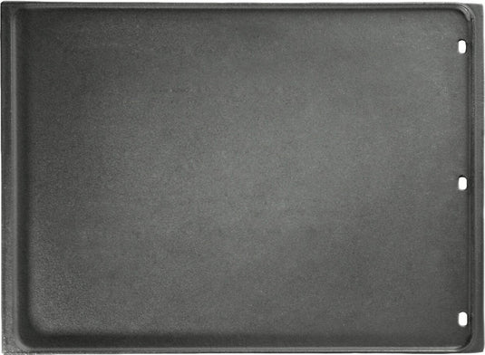 A reversible cast iron griddle with drainage holes, designed for use on a grill as a flexible cooking surface.