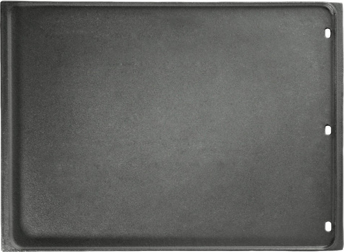 A reversible cast iron griddle with drainage holes, designed for use on a grill as a flexible cooking surface.