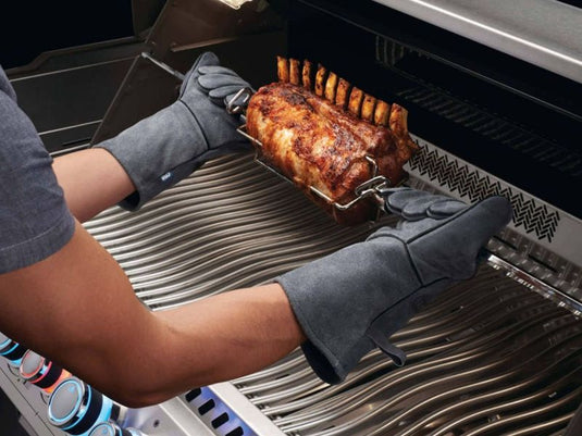 Napoleon Genuine Leather BBQ Gloves in grey cowhide with reinforced stitching for heat protection, extra-long length for forearm shielding, and soft lining for comfort. Includes convenient hanging loops.