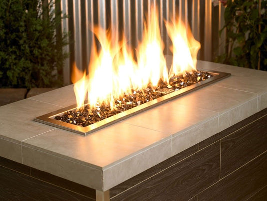 American Fire Products 1/2 inch Black reflective fire glass installed in outdoor fire pit creating dramatic flame reflections