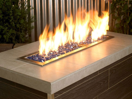 American Fire Products 1/2 inch Cobalt reflective fire glass used in outdoor fire pit with vibrant flame reflection